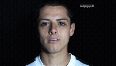 A Man Is Smiling In Front Of A Sky Sports Live Sign GIF