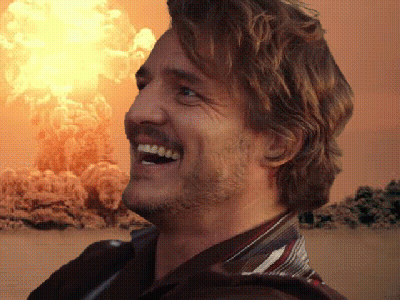 a man is smiling in front of an explosion