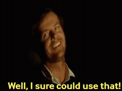 A Man Is Smiling In The Dark With The Words `` Well , I 'M Sure Could Use That '' Behind Him . GIF