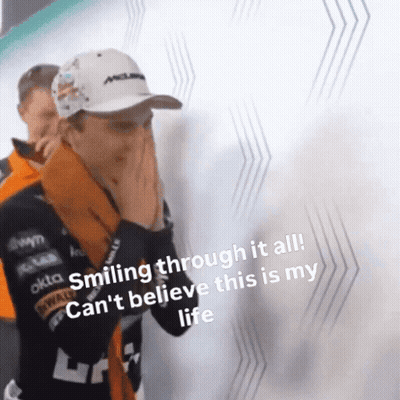 A Man Is Smiling Through It All While Covering His Face With His Hands . GIF