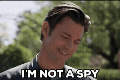 A Man Is Smiling While Saying `` I 'M Not A Spy '' . GIF