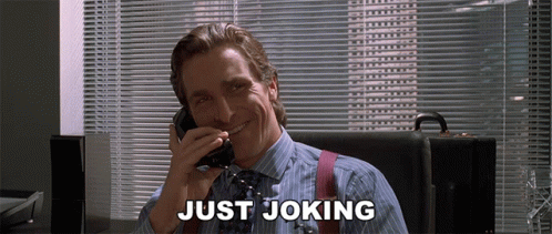 A Man Is Smiling While Talking On A Phone And The Words Just Joking Are Above Him GIF