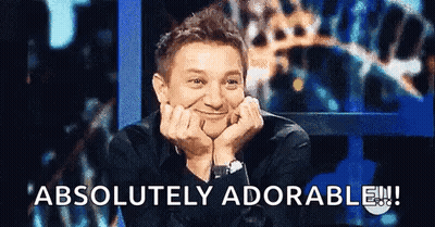 A Man Is Smiling With His Hands On His Face And The Words " Absolutely Adorable " Are Above Him GIF