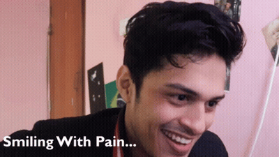 A Man Is Smiling With Pain Written Below Him GIF