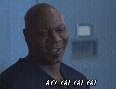 A Man Is Smiling With The Words Ayy Yai Yai Yai Behind Him GIF