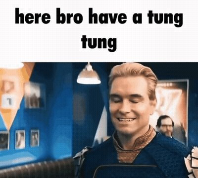 A Man Is Smiling With The Words Here Bro Have A Tung Tung Written Above Him GIF