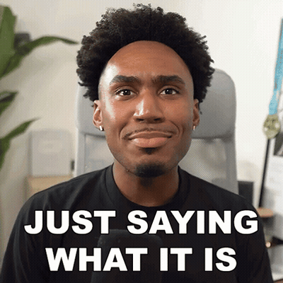 A Man Is Smiling With The Words Just Saying What It Is Behind Him GIF