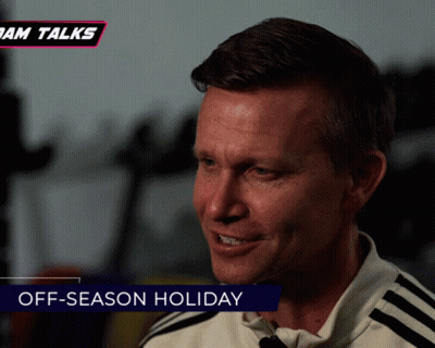 A Man Is Smiling With The Words Off-Season Holiday Behind Him GIF