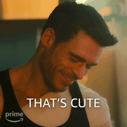 A Man Is Smiling With The Words That 'S Cute Behind Him GIF