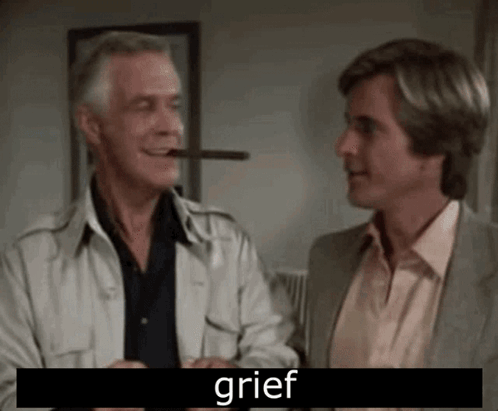 A Man Is Smoking A Cigar While Another Man Looks On . GIF