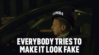 A Man Is Smoking A Cigar While Driving A Car With The Words Everybody Tries To Make It Look Fake . GIF