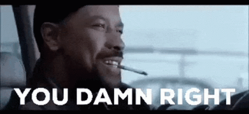 A Man Is Smoking A Cigarette And Smiling While Driving A Car . GIF