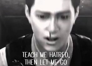 A Man Is Smoking A Cigarette In A Black And White Photo With The Words Teach Me Hatred Then Let Me Go . GIF