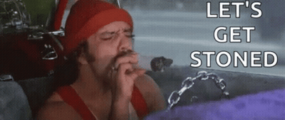 A Man Is Smoking A Cigarette In A Car With The Words `` Let 'S Get Stoned '' Written On The Bottom . GIF