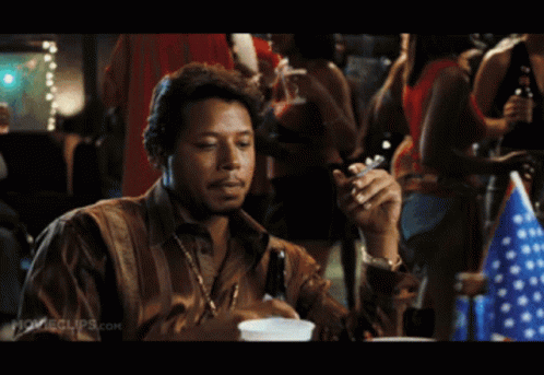 A Man Is Smoking A Cigarette In A Movie Clip GIF