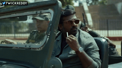 A Man Is Smoking A Cigarette While Sitting In A Car With Wickreddy Written On The Bottom GIF