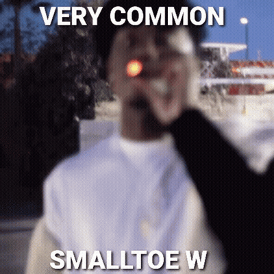 A Man Is Smoking A Cigarette With A Caption That Says Very Common Smalltoe W . GIF