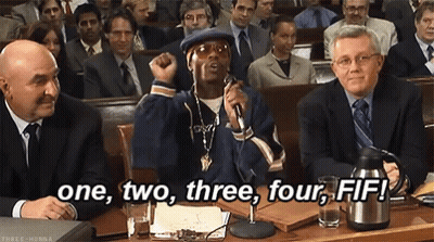 A Man Is Speaking Into A Microphone In Front Of A Crowd And The Words One , Two , Three , Four , Fif GIF