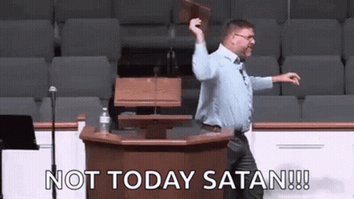 A Man Is Standing At A Podium Holding A Bible And Saying `` Not Today Satan '' . GIF