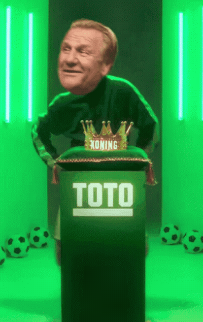 A Man Is Standing Behind A Podium That Says Toto On It GIF