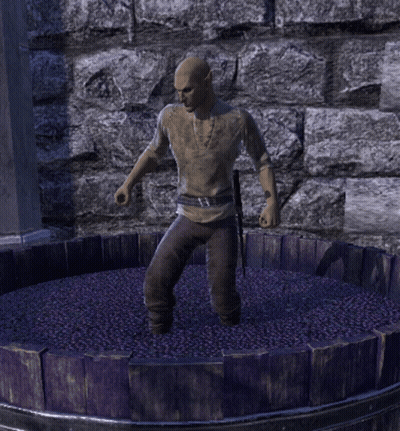 A Man Is Standing In A Barrel Of Grapes GIF