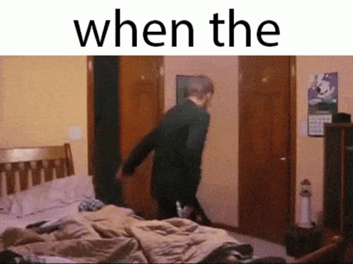 A Man Is Standing In A Bedroom With The Words " When The " Written Above Him GIF