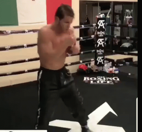 A Man Is Standing In A Boxing Ring With The Word Boxing Life On The Floor GIF
