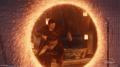 A Man Is Standing In A Circle Of Fire With A Disney Logo On The Bottom GIF