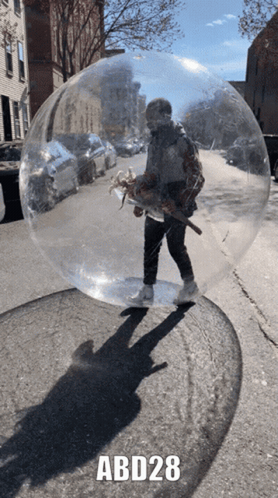 A Man Is Standing In A Clear Bubble With Abd28 Written On The Bottom GIF
