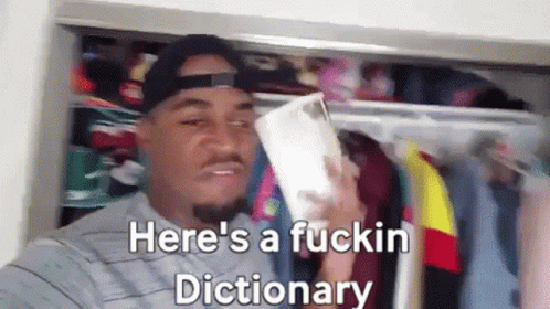 A Man Is Standing In A Closet Holding A Book And Says Here 'S A Fuckin Dictionary GIF