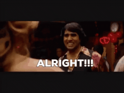 A Man Is Standing In A Crowd With The Word Alright Written On The Screen GIF