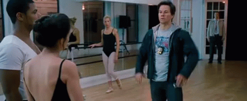 A Man Is Standing In A Dance Studio With A Group Of Dancers . GIF