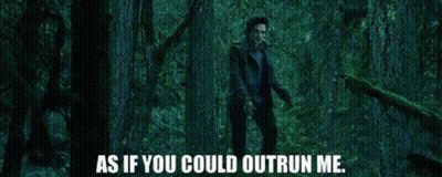 A Man Is Standing In A Dark Forest With The Words As If You Could Outrun Me GIF