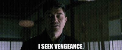 A Man Is Standing In A Dark Room And Saying `` I Seek Vengeance . '' GIF