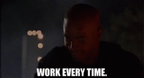 A Man Is Standing In A Dark Room And Says `` Work Every Time '' . GIF