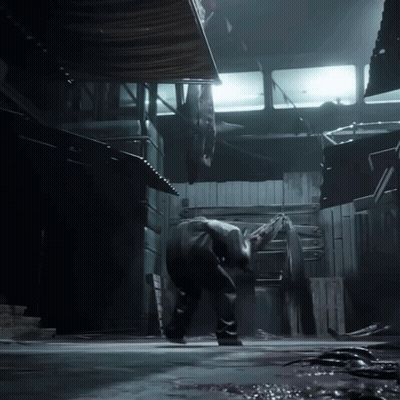 A Man Is Standing In A Dark Room With A Light Shining On Him GIF