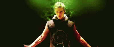A Man Is Standing In A Dark Room With His Arms Outstretched And A Red Shirt On . GIF