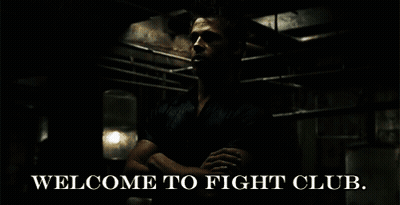 A Man Is Standing In A Dark Room With The Words Welcome To Fight Club GIF
