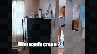 A Man Is Standing In A Doorway Asking Who Wants Cream . GIF