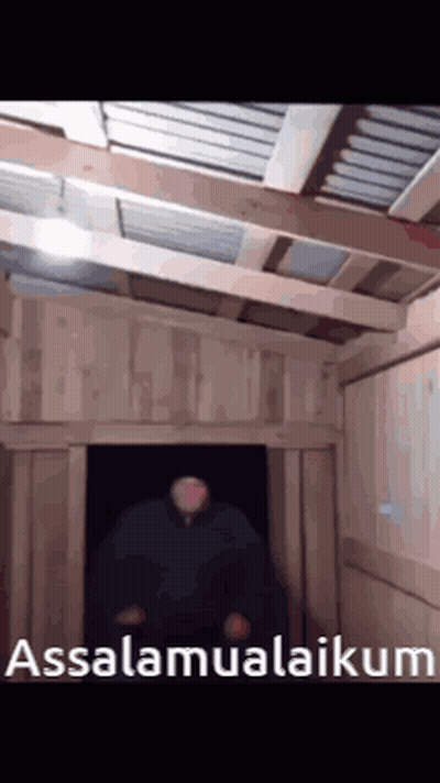 A Man Is Standing In A Doorway With The Words Assalamualaikum Written On The Bottom GIF