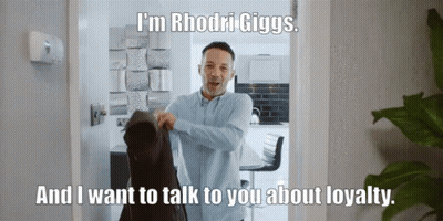 A Man Is Standing In A Doorway With The Words I 'M Rhodri Giggs GIF