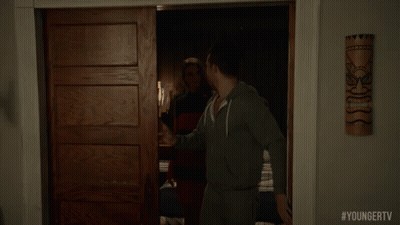 A Man Is Standing In A Doorway With #Youngertv Written On The Bottom Of The Screen GIF
