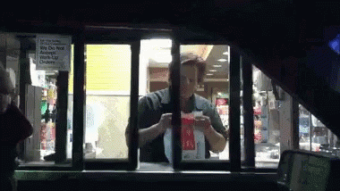 A Man Is Standing In A Drive Thru Window With A Sign That Says We Do Not Accept Credit Cards GIF