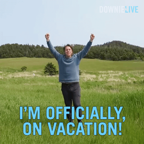 A Man Is Standing In A Field With His Arms In The Air And The Words " I 'M Officially On Vacation " GIF