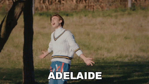 A Man Is Standing In A Field With The Word Adelaide Written On The Bottom GIF