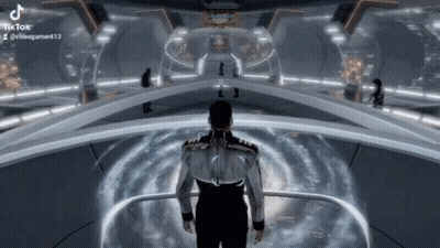 A Man Is Standing In A Futuristic Room In A Video Game And Looking At Something . GIF