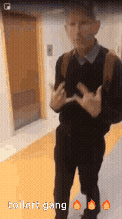 A Man Is Standing In A Hallway With The Words Toilet Gang On The Bottom Right GIF