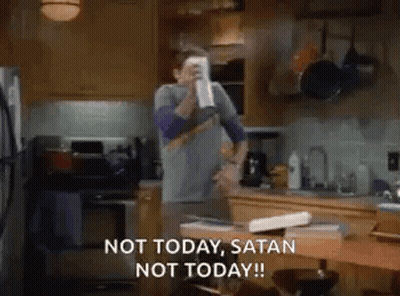 A Man Is Standing In A Kitchen Holding A Cup In His Hand And Saying `` Not Today , Satan Not Today '' . GIF