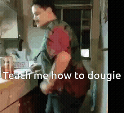 A Man Is Standing In A Kitchen With The Words Teach Me How To Dougie On The Bottom GIF