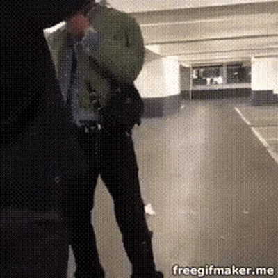 A Man Is Standing In A Parking Garage With A Freegifmaker.me Logo In The Corner GIF